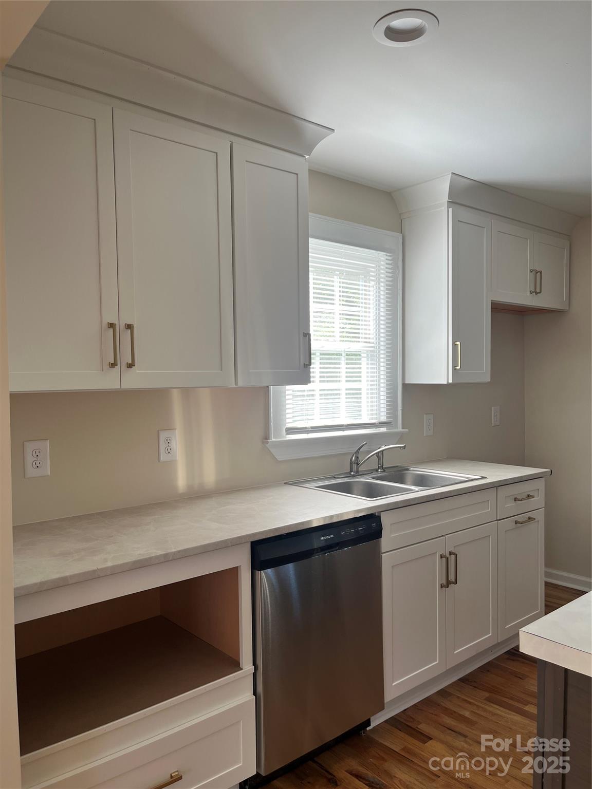 60 3rd Street Concord, NC 28025 - Photo 4 of 10 a kitchen with a sink stove and cabinets