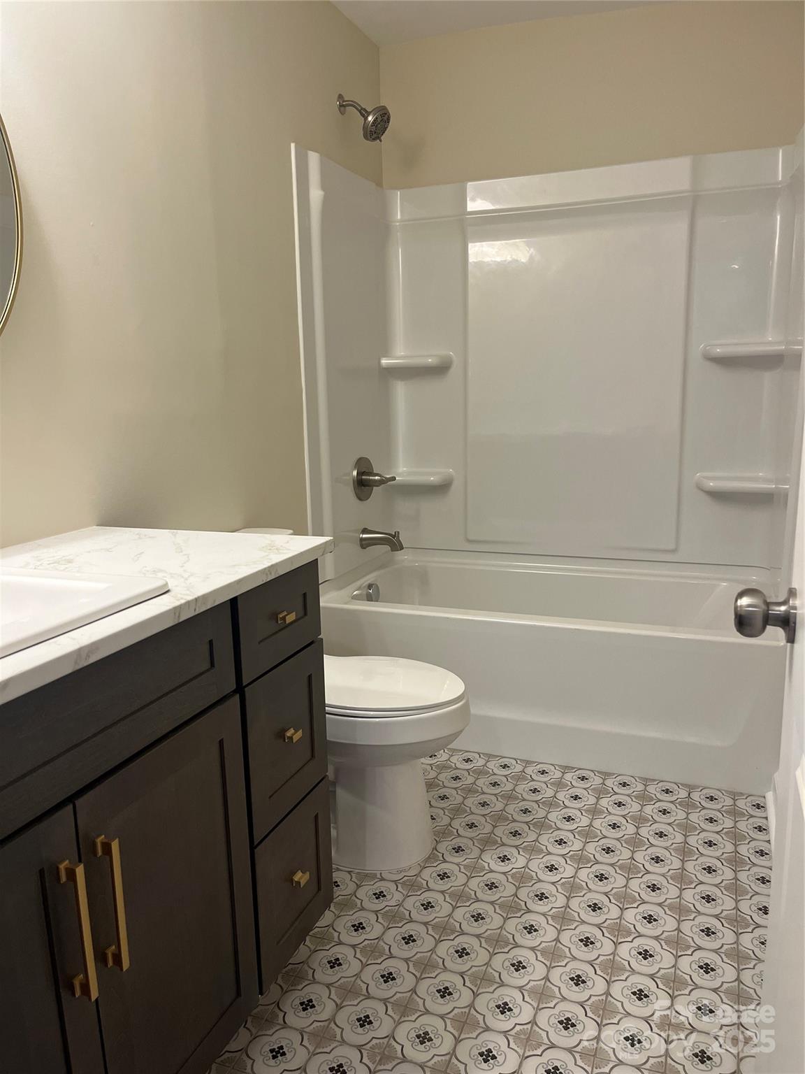 60 3rd Street Concord, NC 28025 - Photo 6 of 10 a bathroom with a sink a toilet and shower