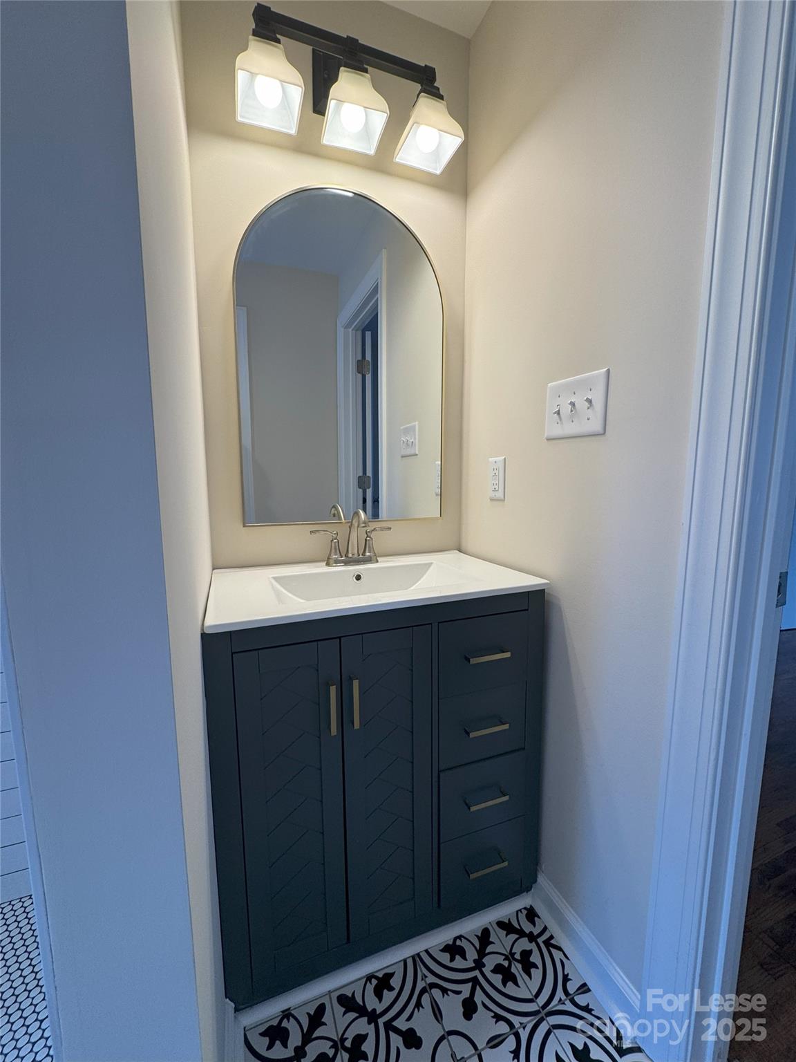 60 3rd Street Concord, NC 28025 - Photo 9 of 10 a bathroom with a sink and a mirror