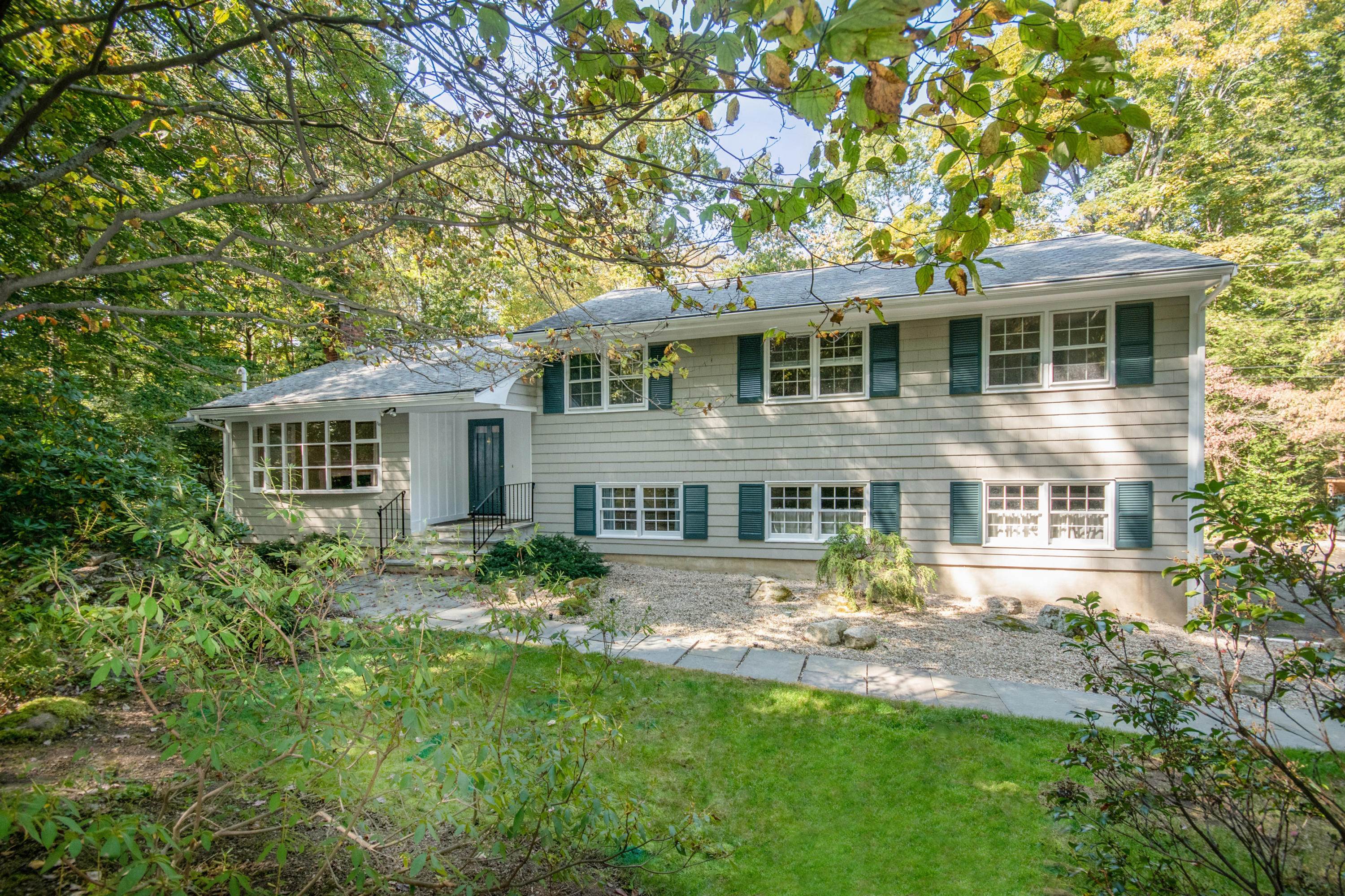 54 Huckleberry Hill Road New Canaan, CT 06840 - Photo 1 of 37 a front view of a house with yard and green space