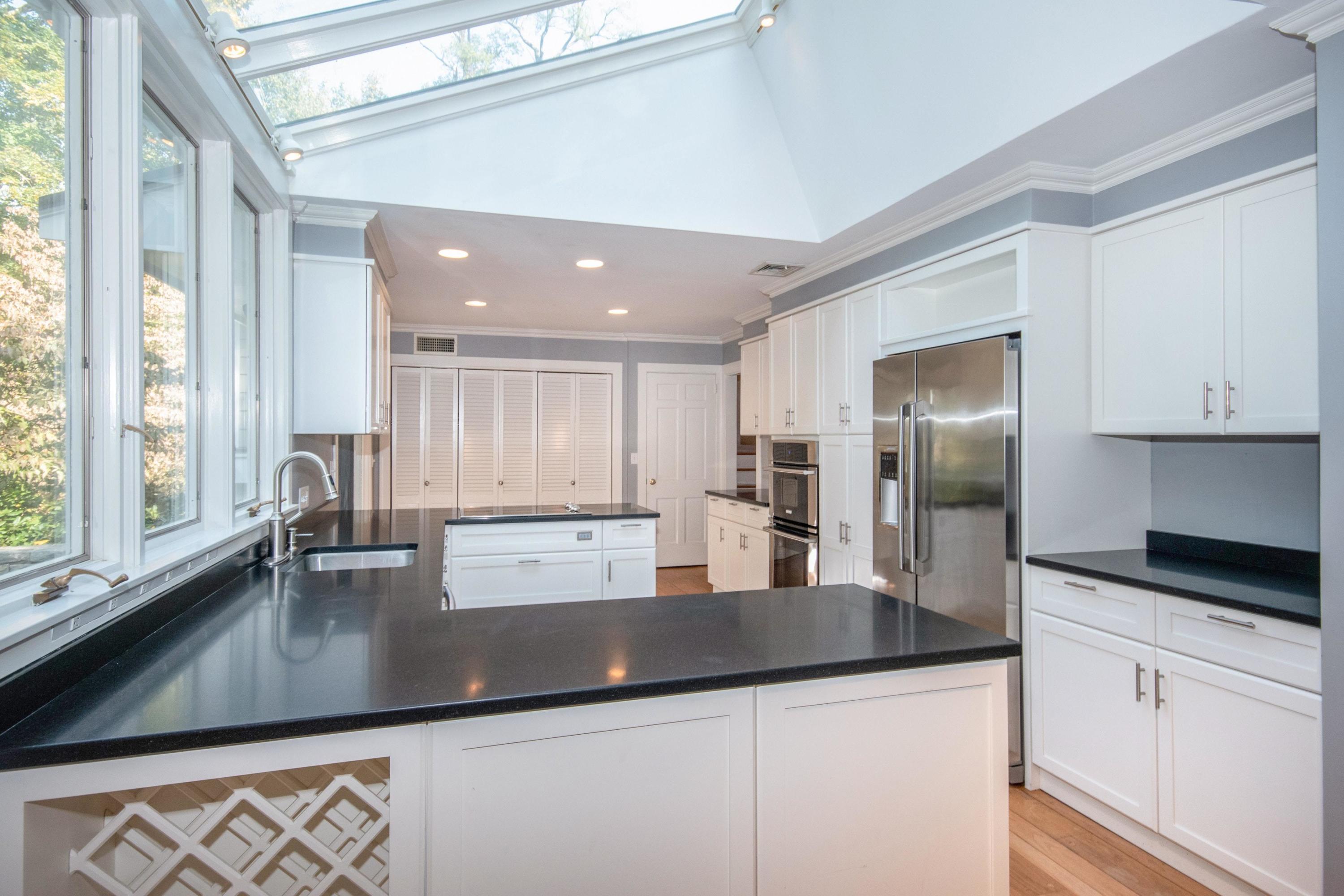 54 Huckleberry Hill Road New Canaan, CT 06840 - Photo 11 of 37 a kitchen with stainless steel appliances granite countertop a sink refrigerator and cabinets
