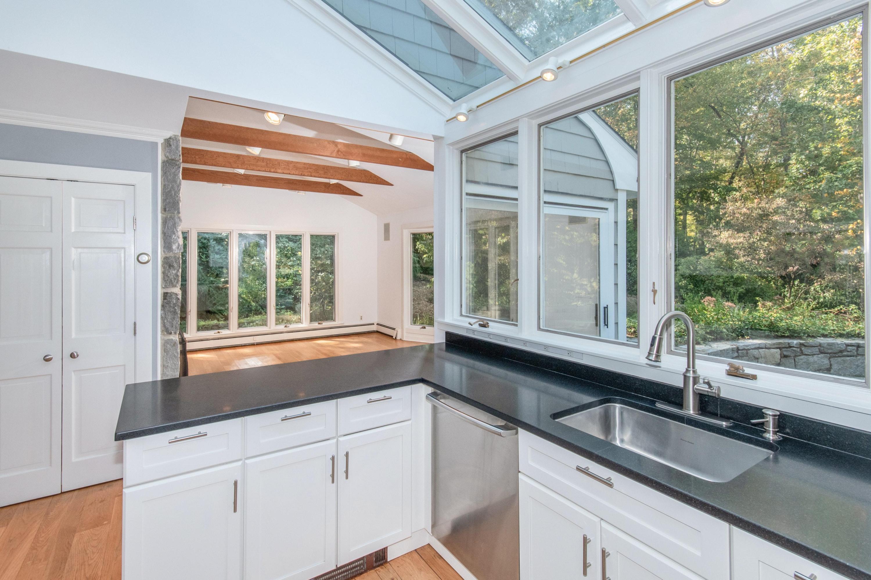 54 Huckleberry Hill Road New Canaan, CT 06840 - Photo 12 of 37 a kitchen with granite countertop a sink and a large window