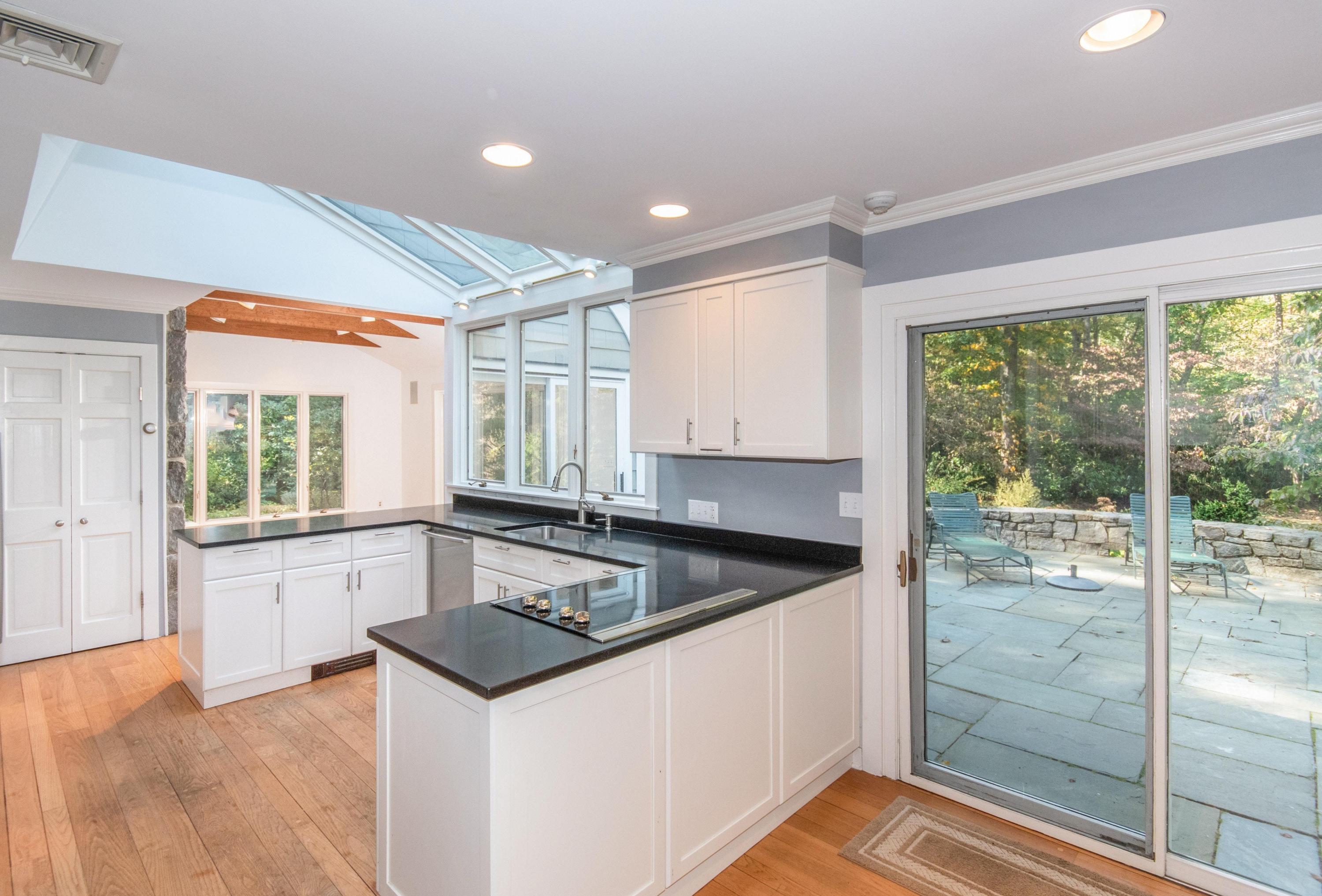 54 Huckleberry Hill Road New Canaan, CT 06840 - Photo 14 of 37 a kitchen that has a sink and a granite counter tops