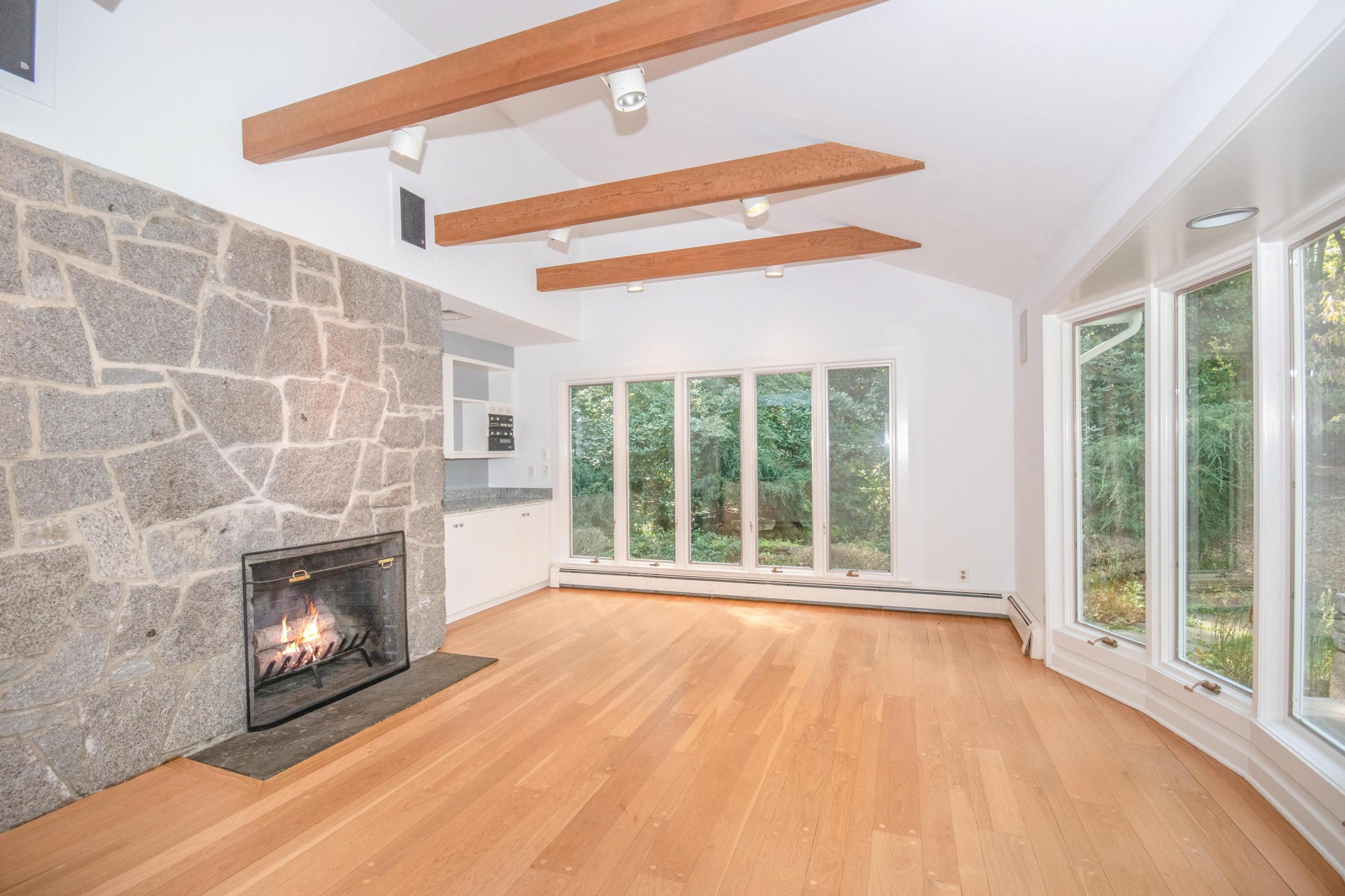54 Huckleberry Hill Road New Canaan, CT 06840 - Photo 15 of 37 a view of an empty room with a fireplace and a window