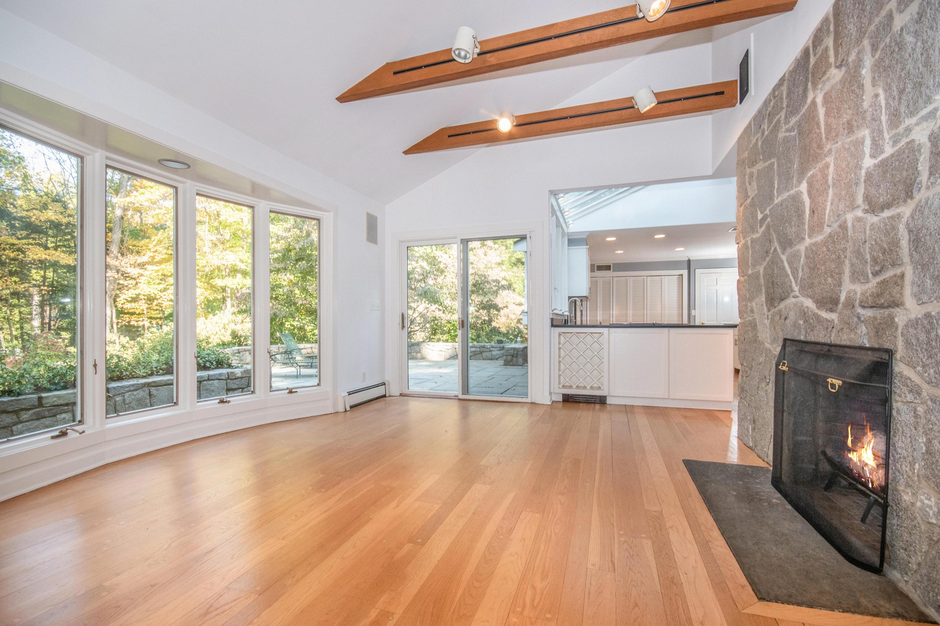 54 Huckleberry Hill Road New Canaan, CT 06840 - Photo 16 of 37 a view of a room with wooden floor and a fireplace