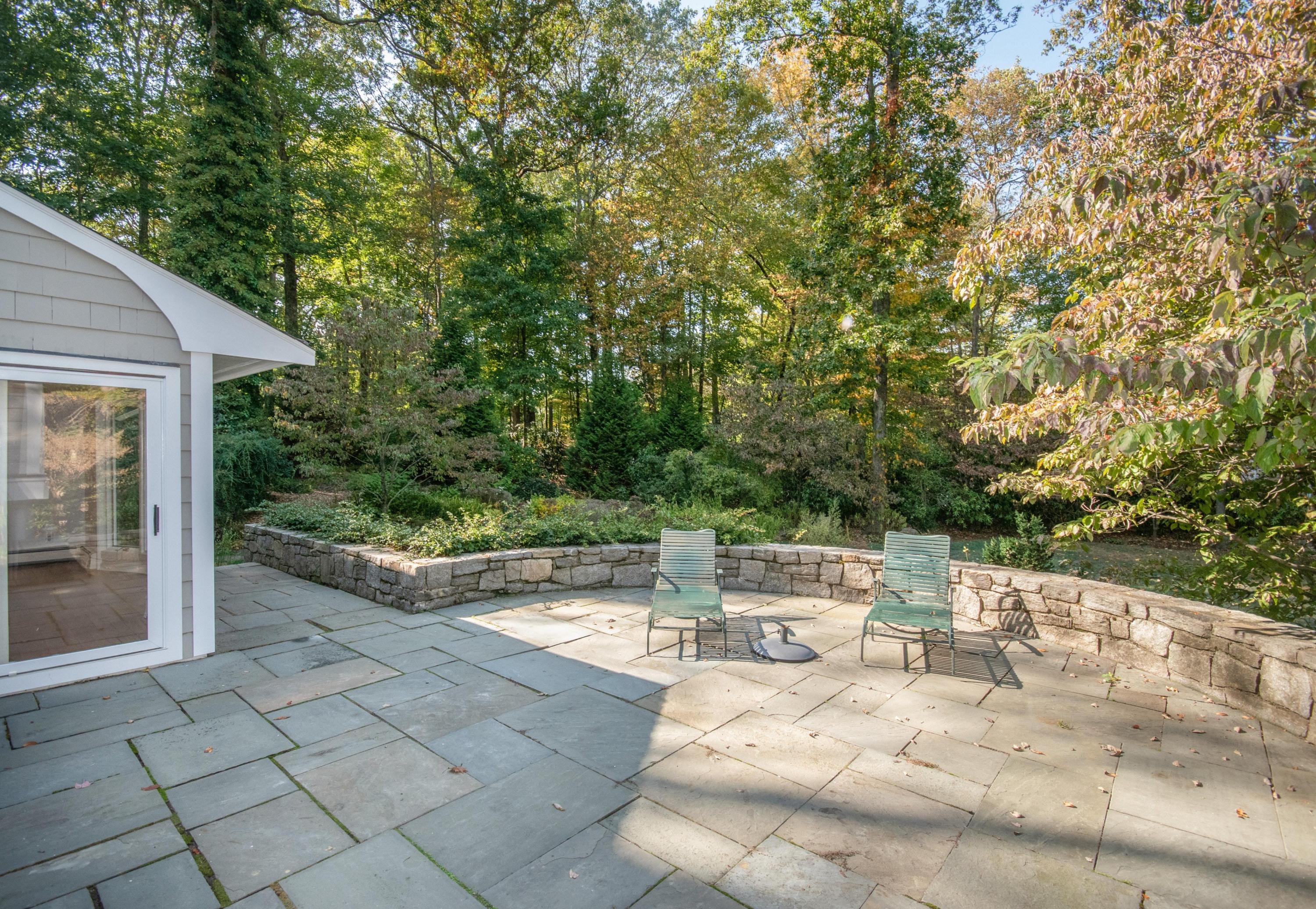 54 Huckleberry Hill Road New Canaan, CT 06840 - Photo 17 of 37 a view of backyard of house with seating space