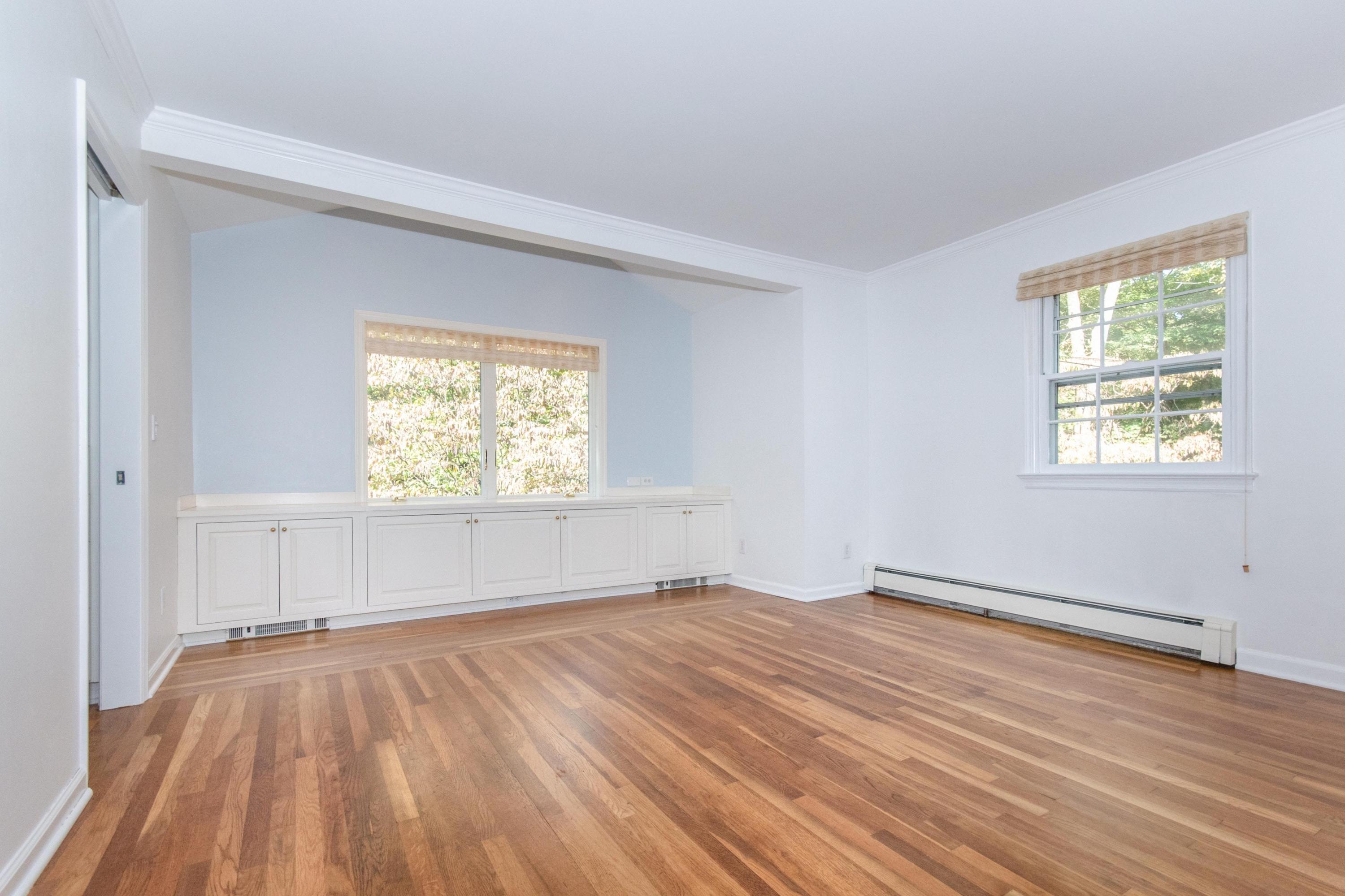 54 Huckleberry Hill Road New Canaan, CT 06840 - Photo 19 of 37 an empty room with wooden floor and windows