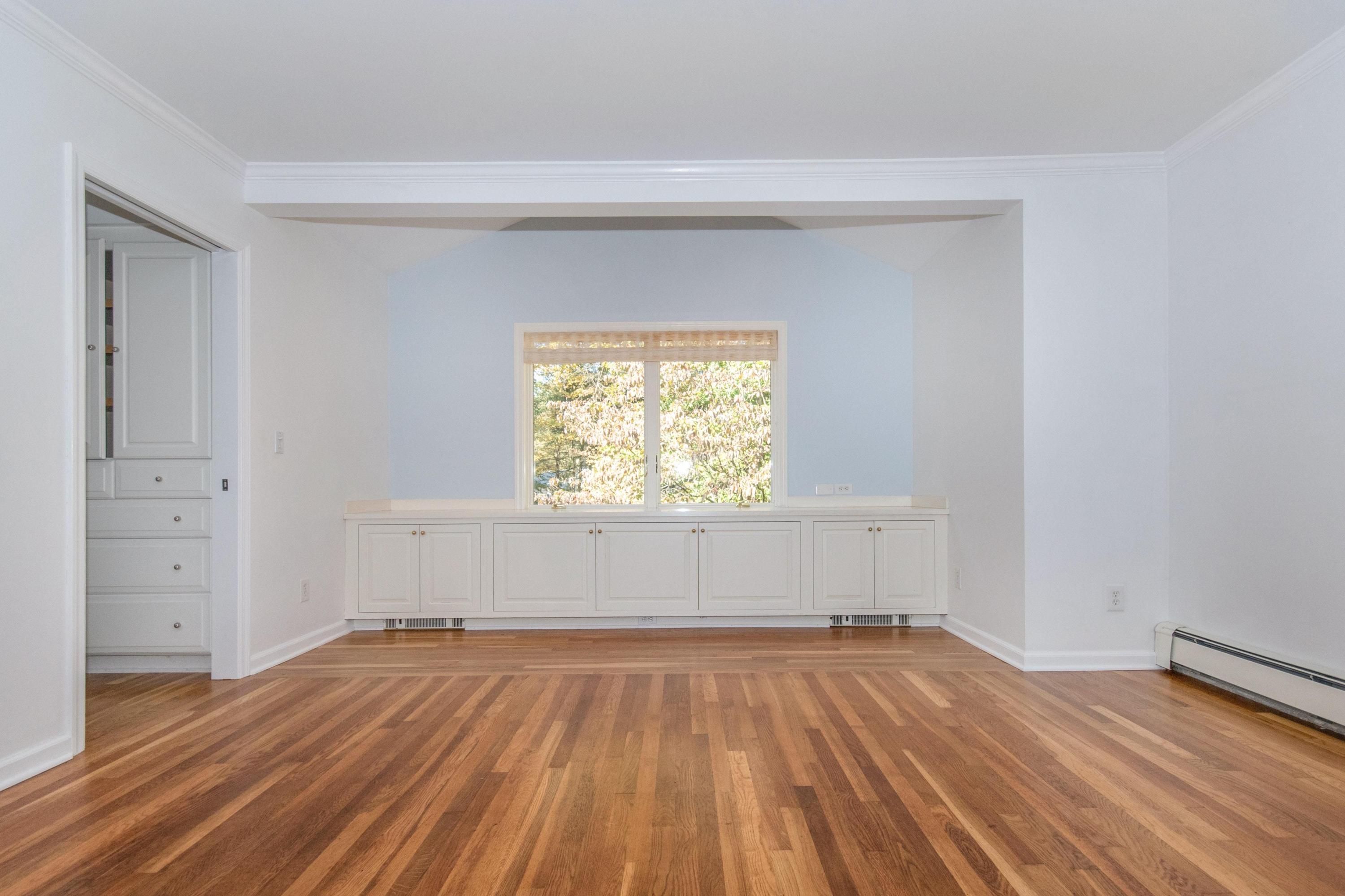 54 Huckleberry Hill Road New Canaan, CT 06840 - Photo 20 of 37 an empty room with wooden floor and windows