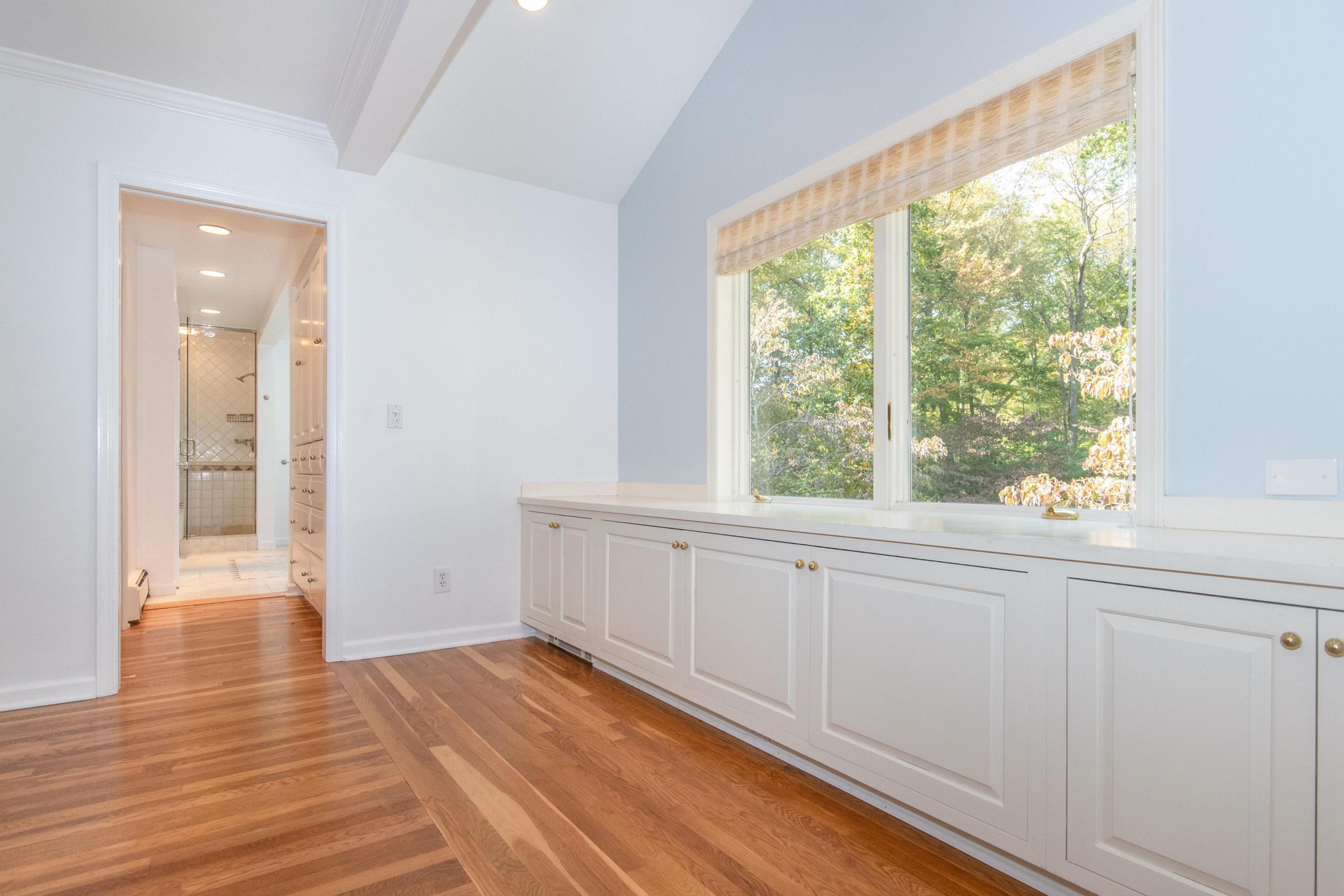 54 Huckleberry Hill Road New Canaan, CT 06840 - Photo 21 of 37 a view of an empty room with wooden floor and a window