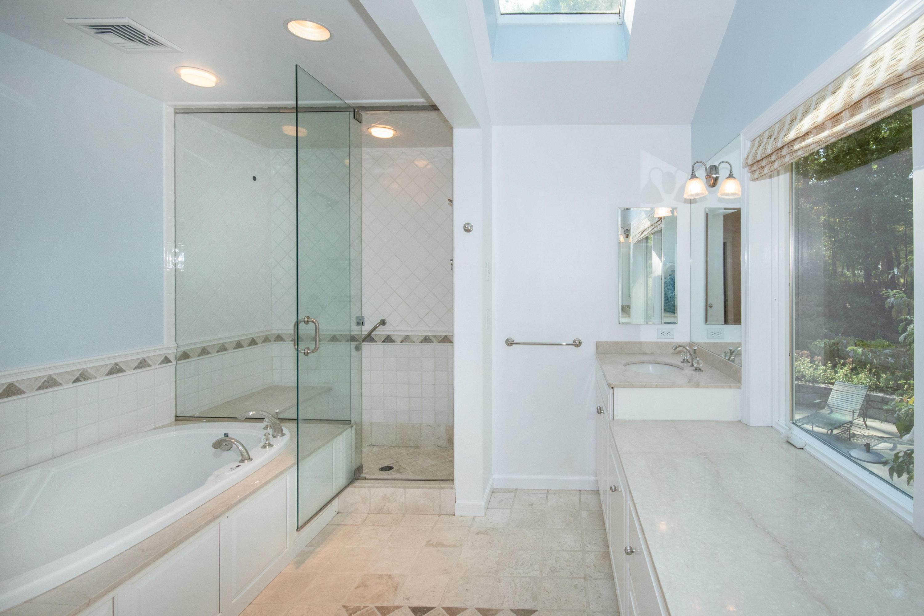 54 Huckleberry Hill Road New Canaan, CT 06840 - Photo 22 of 37 a spacious bathroom with a tub shower sink and mirror