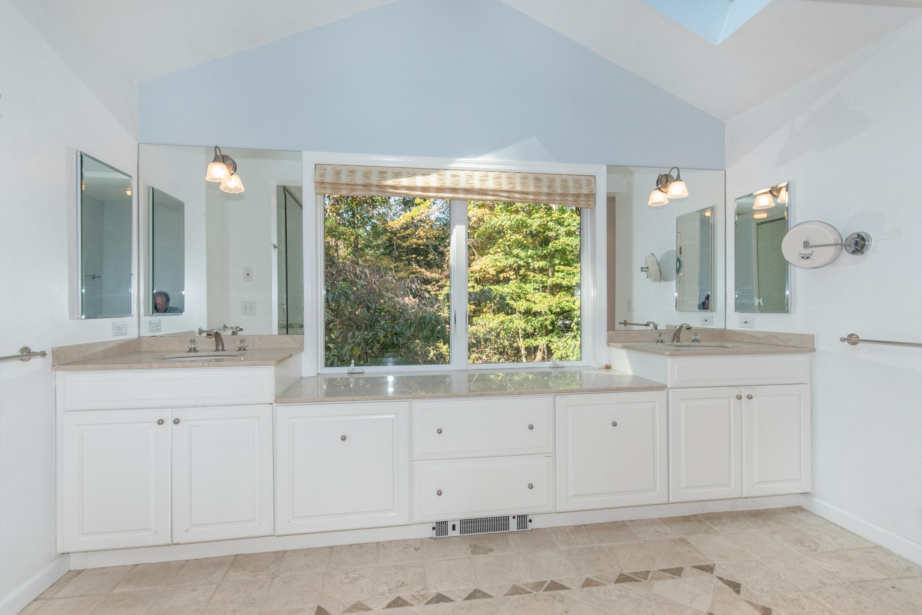 54 Huckleberry Hill Road New Canaan, CT 06840 - Photo 23 of 37 a bathroom with a sink and a mirror