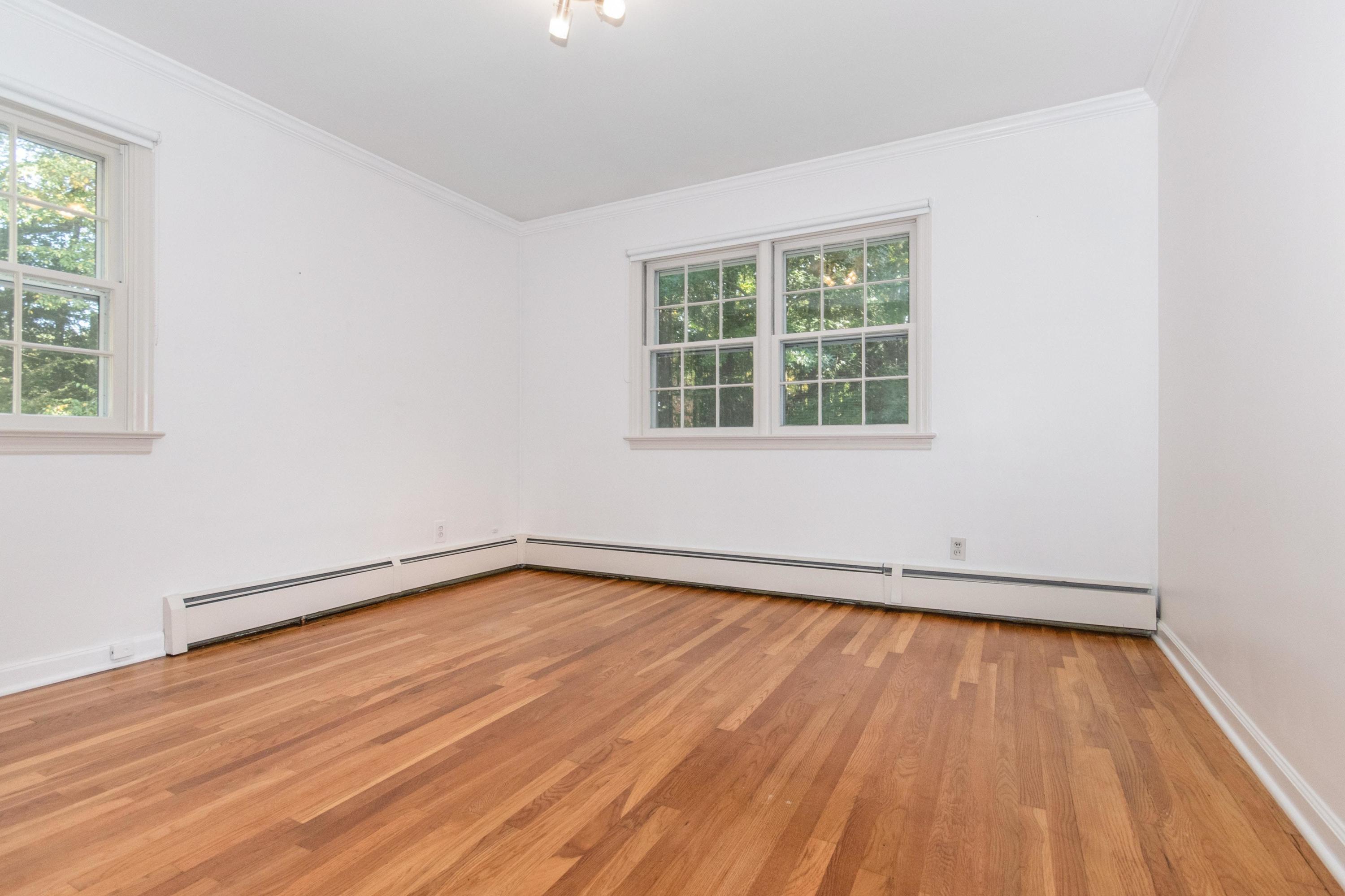 54 Huckleberry Hill Road New Canaan, CT 06840 - Photo 25 of 37 an empty room with wooden floor and windows