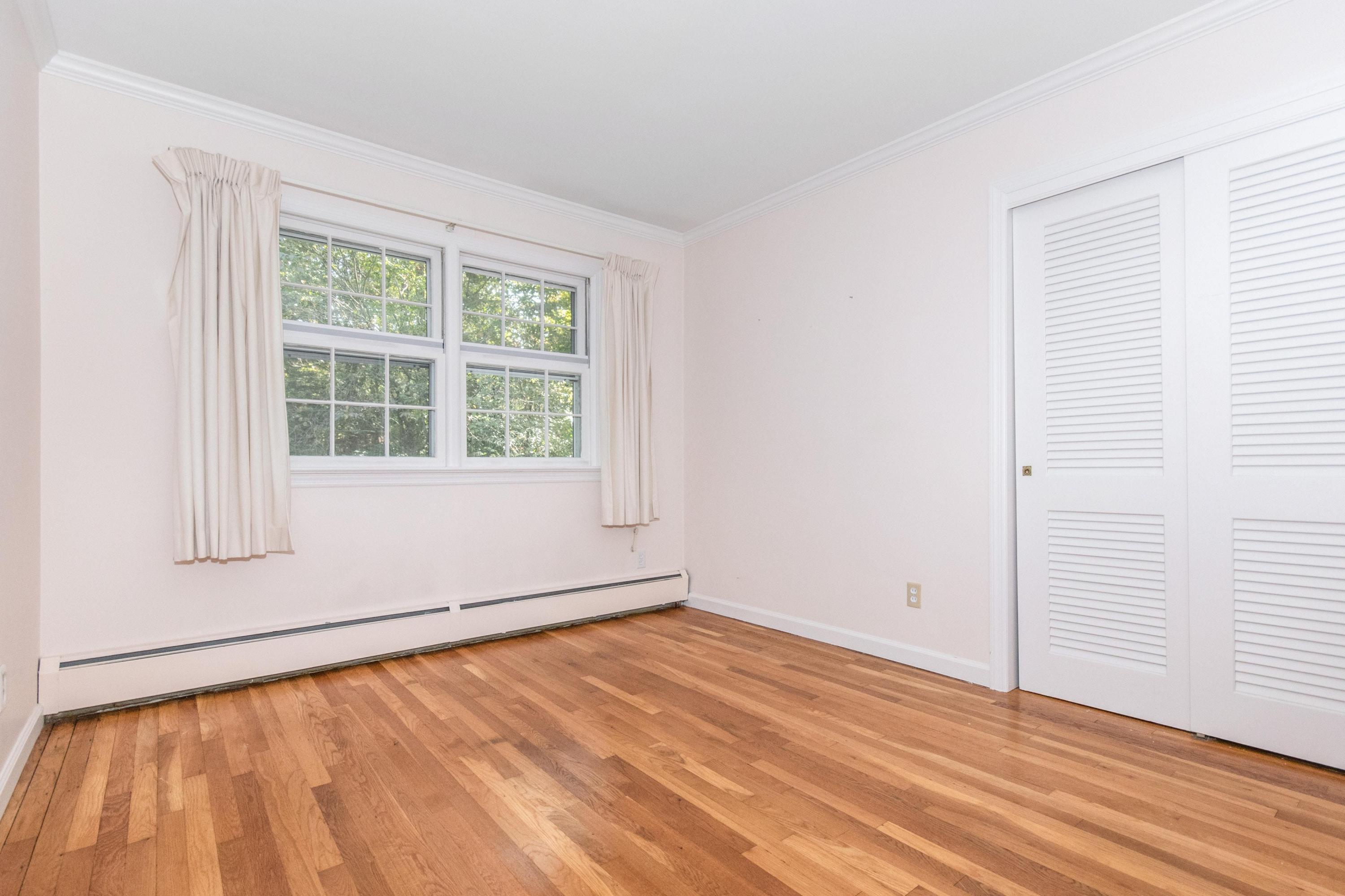 54 Huckleberry Hill Road New Canaan, CT 06840 - Photo 26 of 37 an empty room with wooden floor and windows