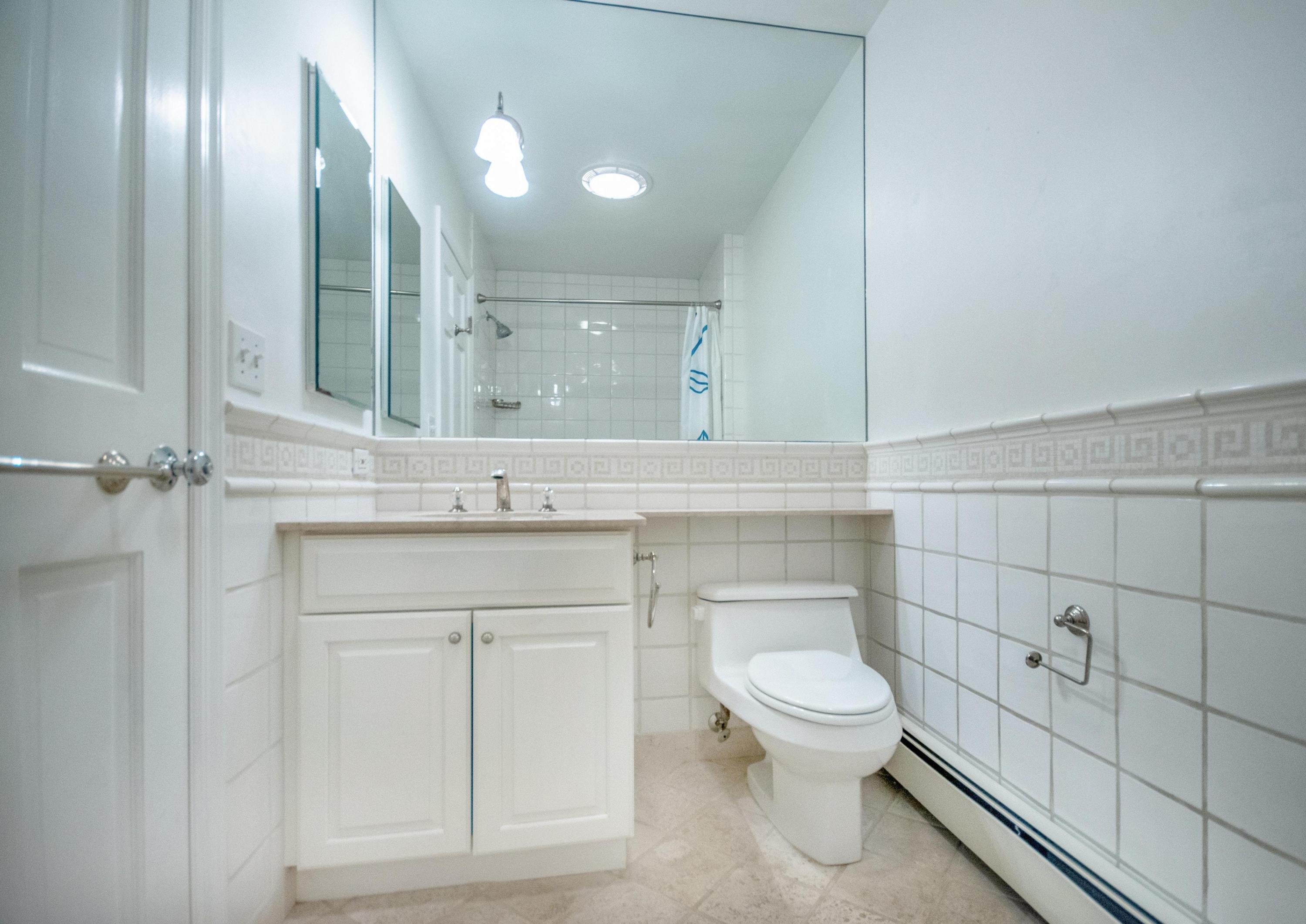 54 Huckleberry Hill Road New Canaan, CT 06840 - Photo 27 of 37 a bathroom with a toilet a sink and mirror