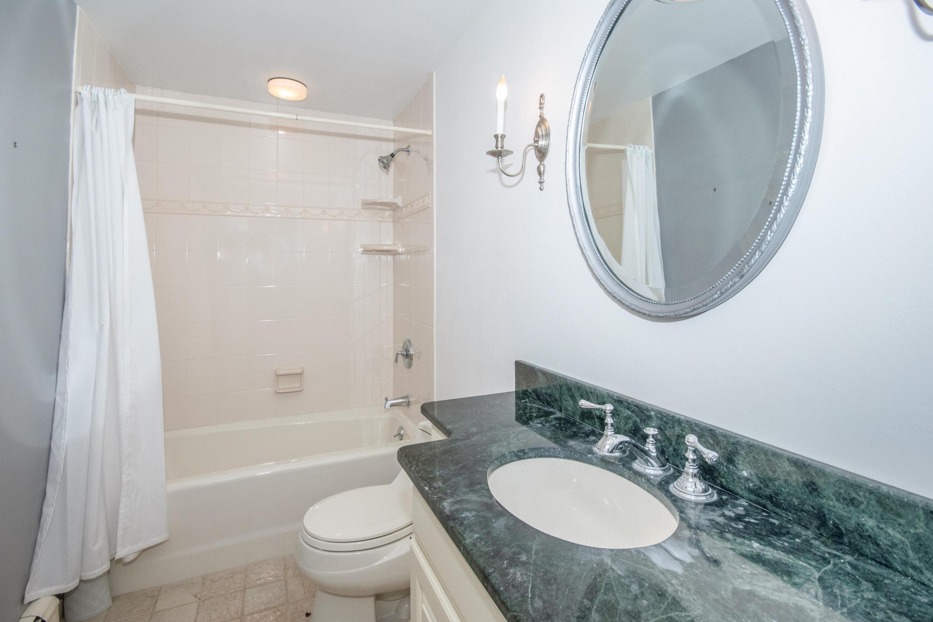 54 Huckleberry Hill Road New Canaan, CT 06840 - Photo 28 of 37 a bathroom with a granite countertop sink toilet a shower and a mirror