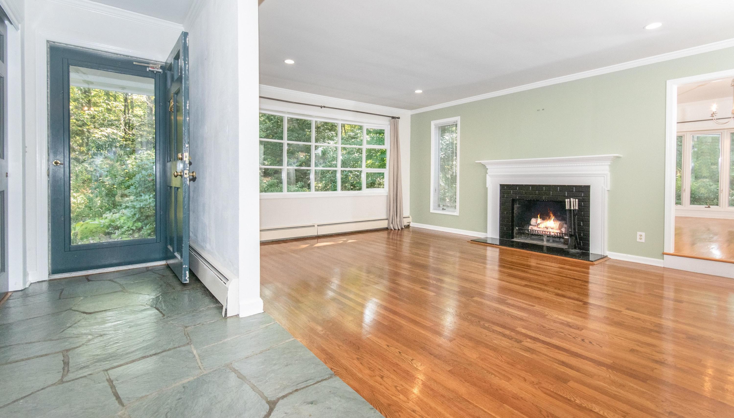 54 Huckleberry Hill Road New Canaan, CT 06840 - Photo 4 of 37 a view of an empty room with glass door and wooden floor