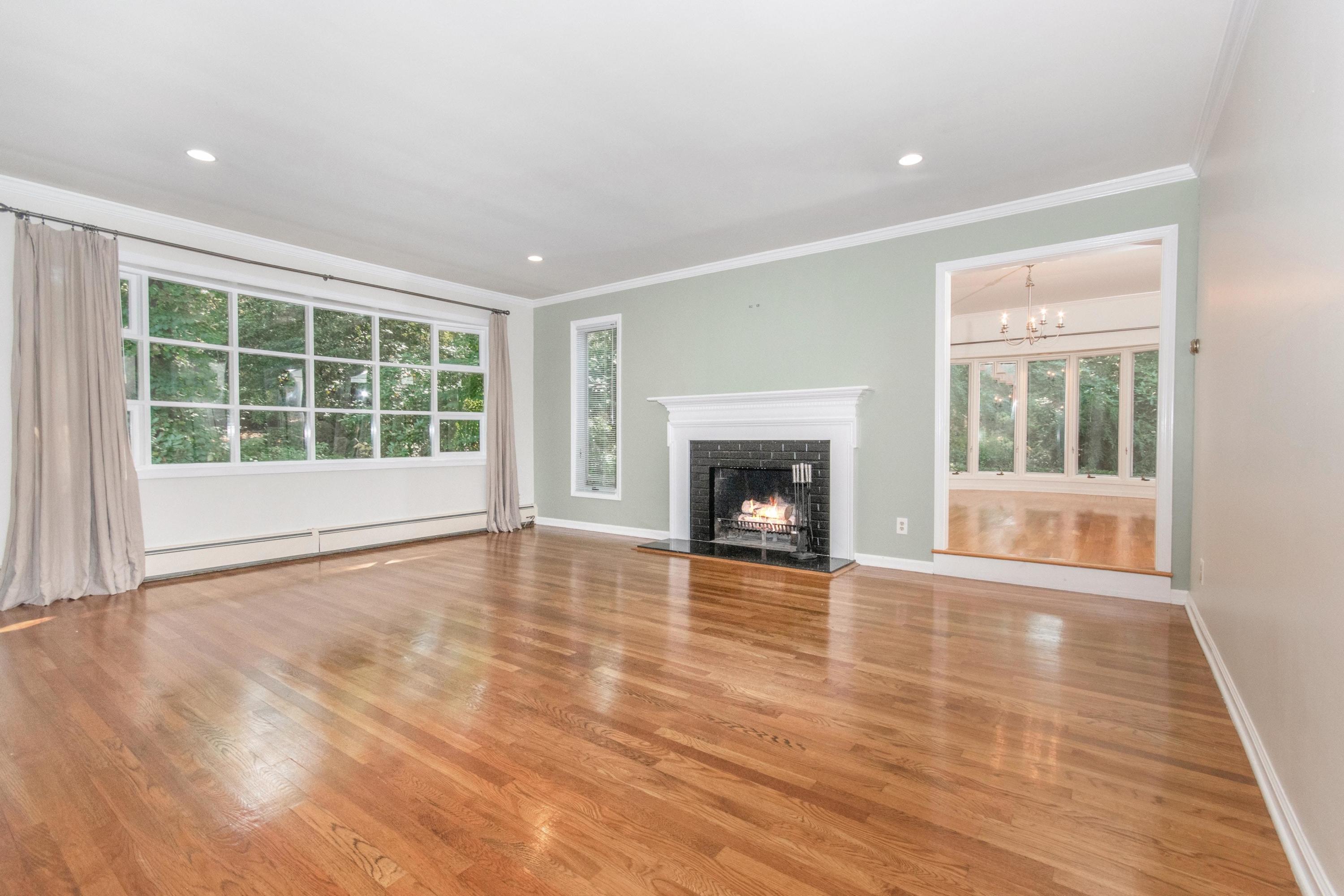 54 Huckleberry Hill Road New Canaan, CT 06840 - Photo 5 of 37 a view of empty room with wooden floor and fireplace