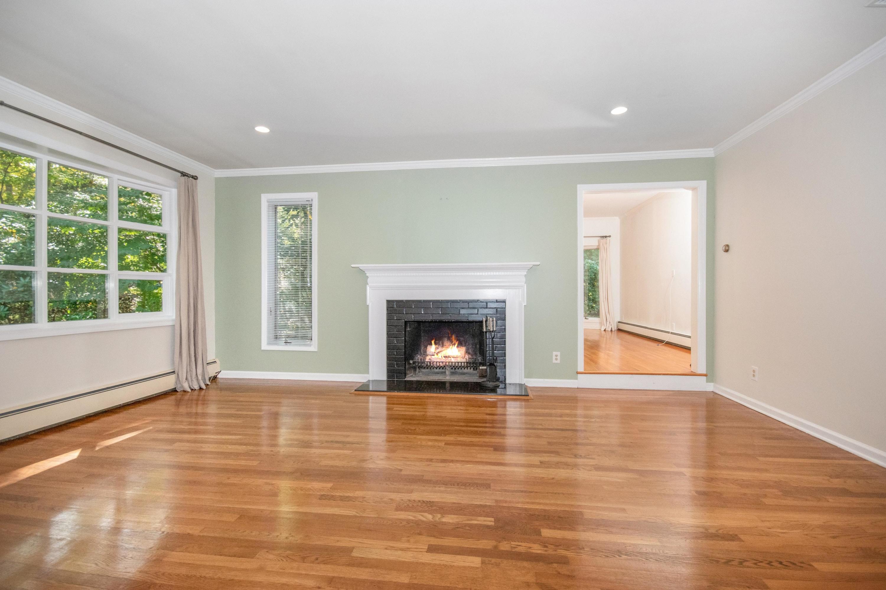 54 Huckleberry Hill Road New Canaan, CT 06840 - Photo 6 of 37 a view of an empty room with glass door and wooden floor