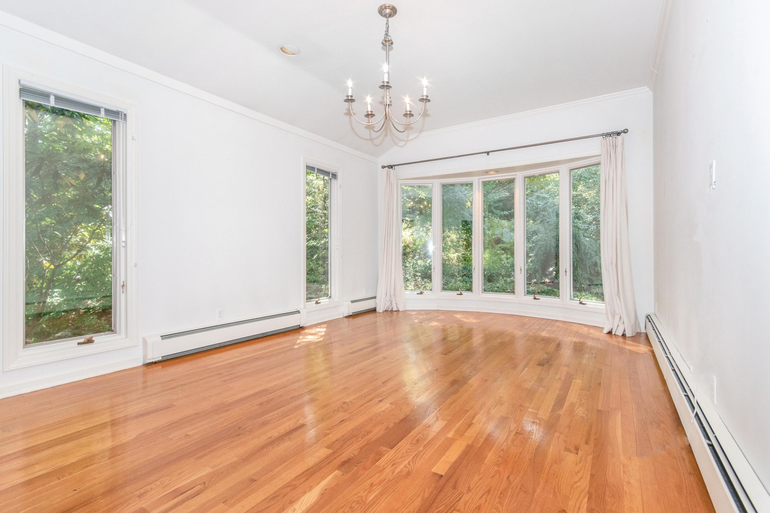 54 Huckleberry Hill Road New Canaan, CT 06840 - Photo 8 of 37 a view of an empty room with wooden floor and a window