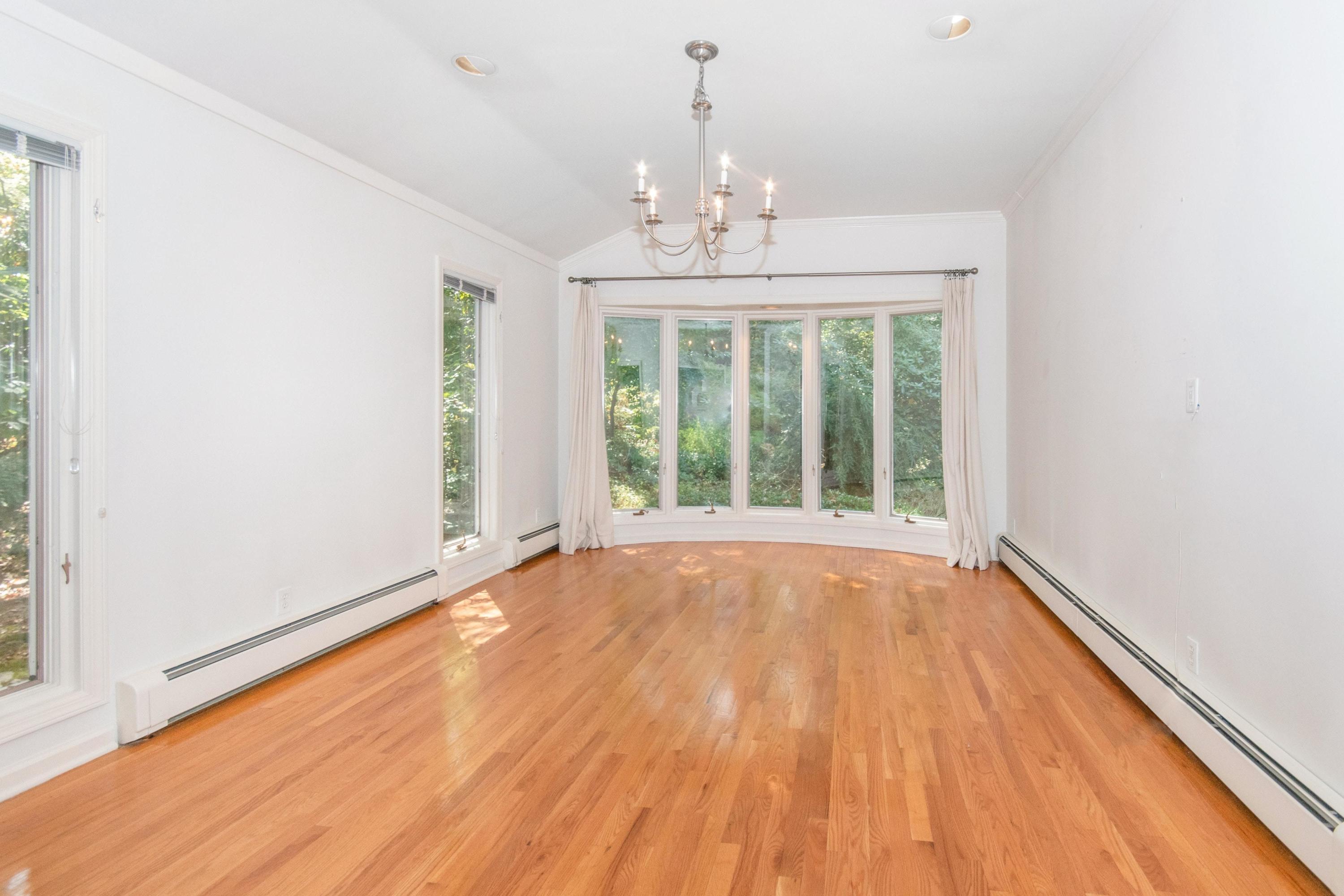 54 Huckleberry Hill Road New Canaan, CT 06840 - Photo 9 of 37 a view of an empty room with wooden floor and a window