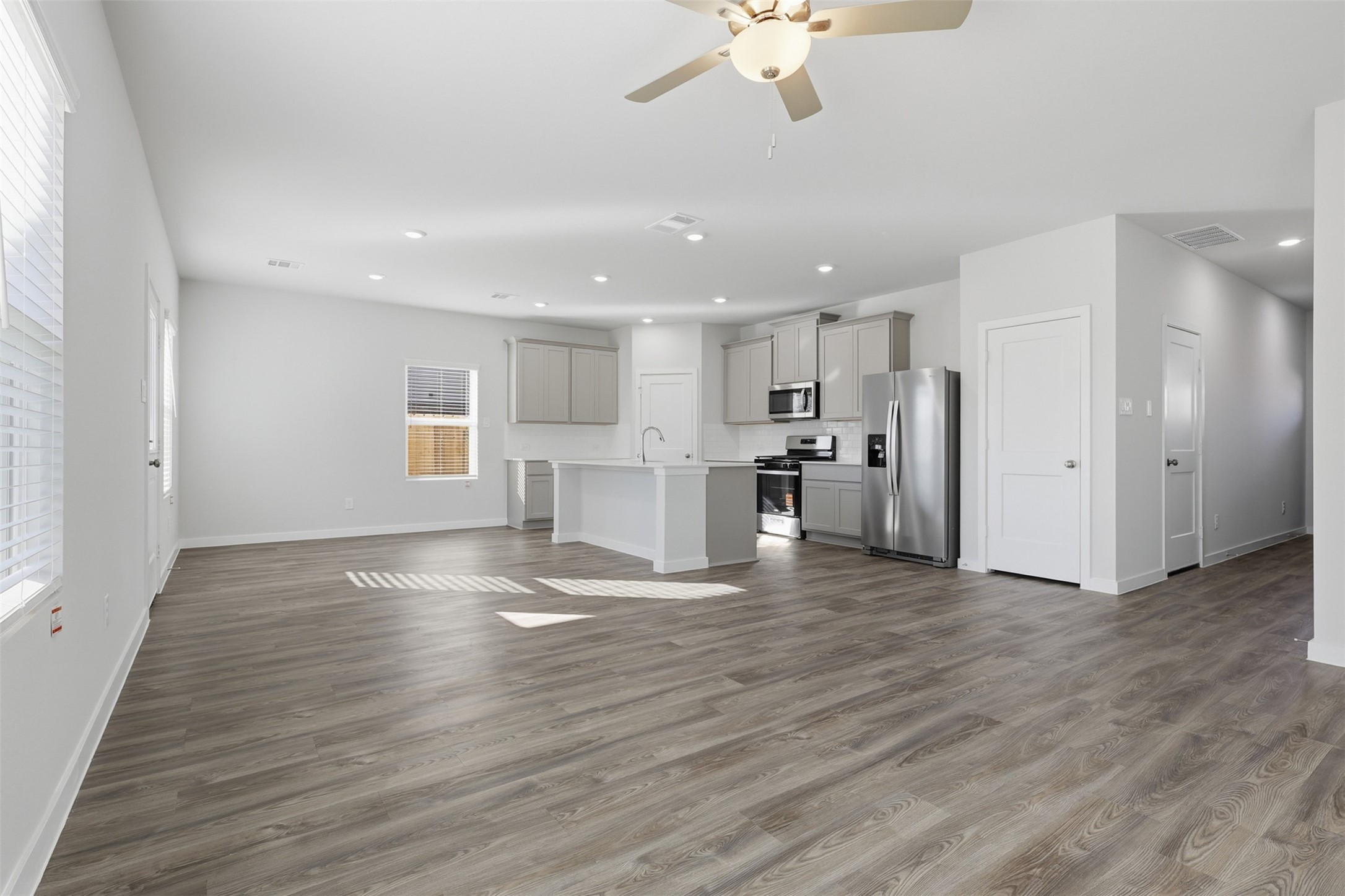 211 Brazen Forest Trail Magnolia, TX 77355 - Photo 4 of 14 a view of a kitchen with a sink and a refrigerator