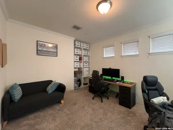 a livingroom with workspace couch and a window