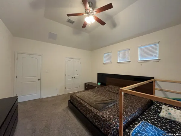 a bedroom with a bed and ceiling fan