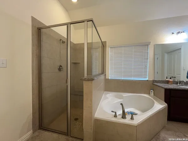 a bathroom with a bathtub and a shower