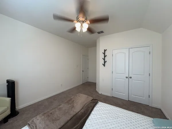 a view of a chandelier fan and entryway