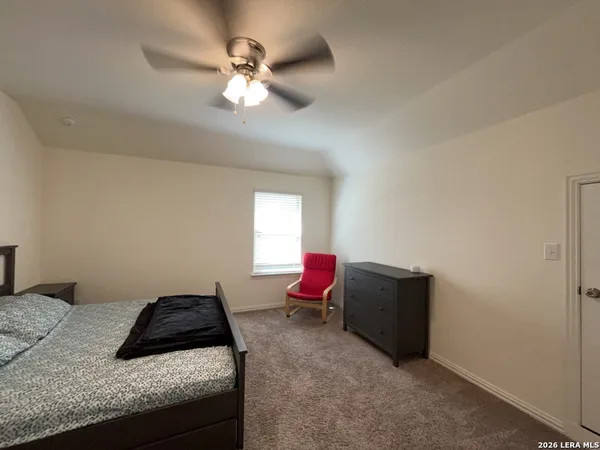 a bedroom with bed and window