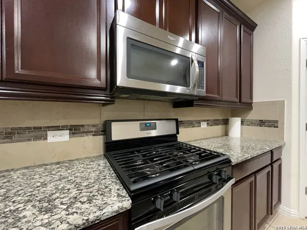 a kitchen with a stove and a microwave
