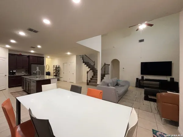 a large kitchen with a table and chairs