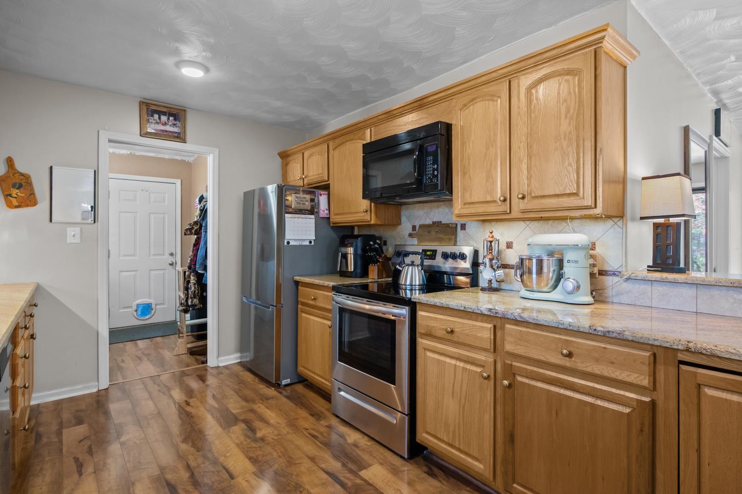 41 Golden Pond Circle Holladay, TN 38341 - Photo 11 of 42 a kitchen with stainless steel appliances granite countertop a stove a sink and a refrigerator