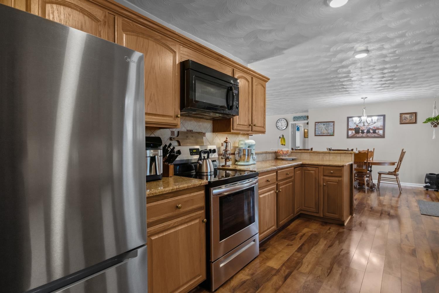41 Golden Pond Circle Holladay, TN 38341 - Photo 13 of 42 a kitchen with stainless steel appliances granite countertop a refrigerator stove and sink