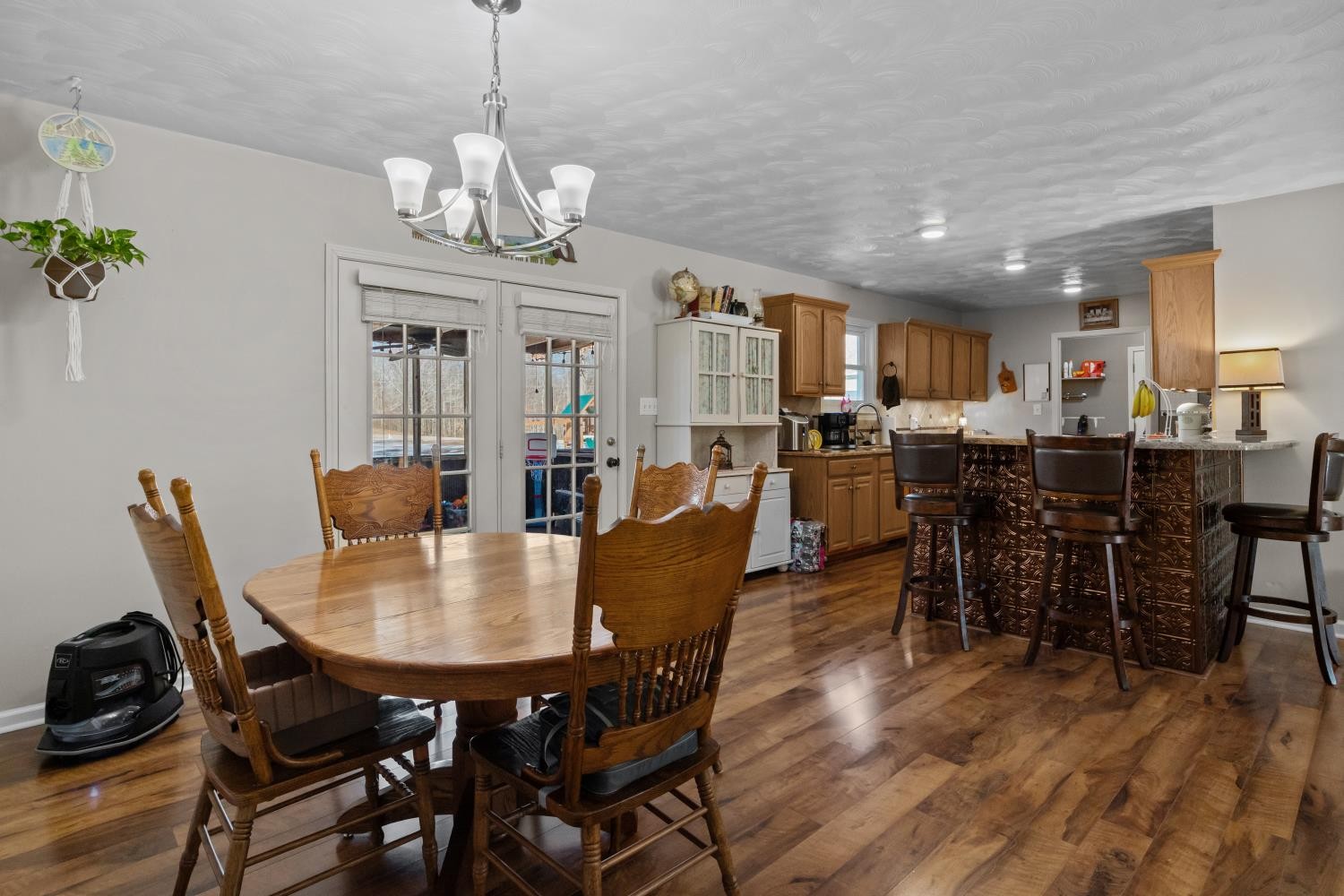 41 Golden Pond Circle Holladay, TN 38341 - Photo 15 of 42 a dining room with wooden floor a chandelier a wooden table and chairs