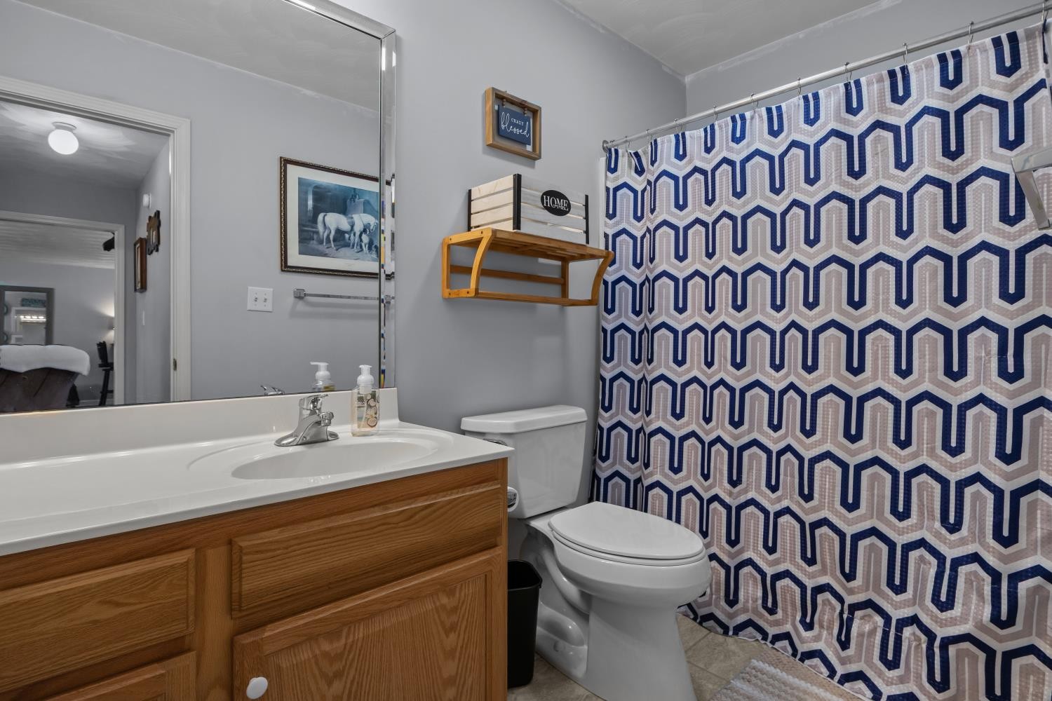 41 Golden Pond Circle Holladay, TN 38341 - Photo 26 of 42 a bathroom with a sink a toilet and a mirror