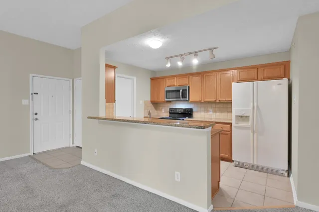 a view of a kitchen with a sink and chandelier