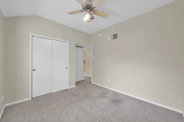 a view of a kitchen with white cabinets and wooden floor