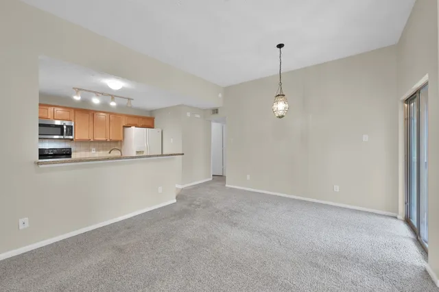 a kitchen with stainless steel appliances granite countertop a refrigerator a stove top oven a sink and dishwasher