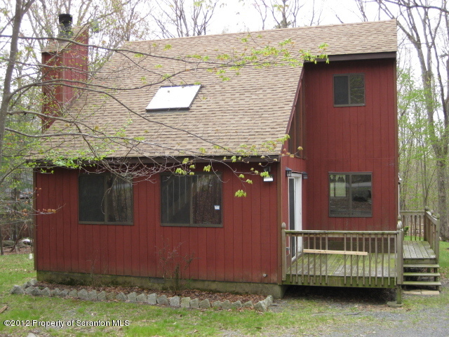 201 Butternut Road Milford, PA 18337 - Photo 1 of 10 a brick house with large windows and a yard
