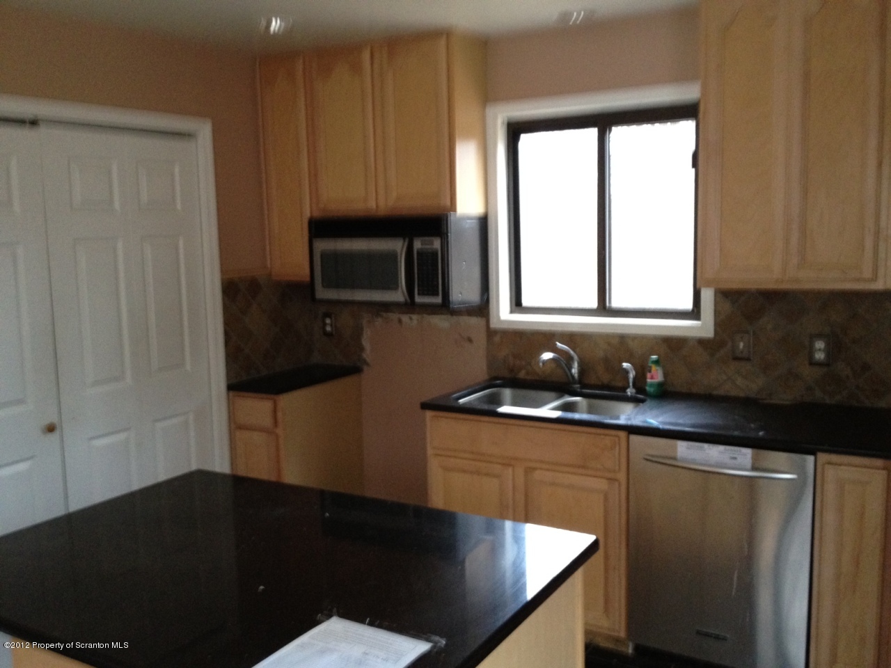 201 Butternut Road Milford, PA 18337 - Photo 5 of 10 a kitchen with granite countertop white cabinets sink and window