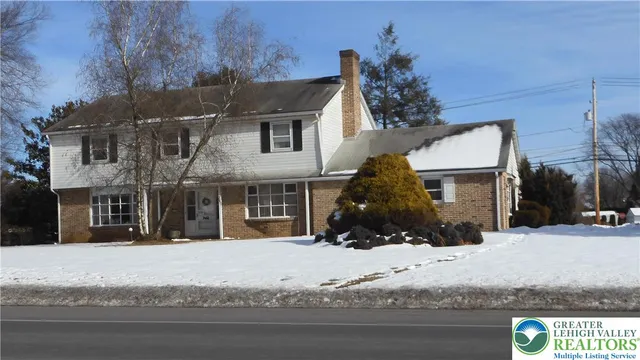 a view of a house with a snow on the road