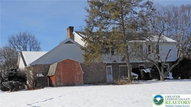 a view of a house with a snow in the yard