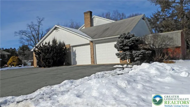 a view of a house with a snow in the yard