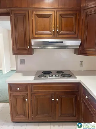 a kitchen with granite countertop white cabinets and stainless steel appliances