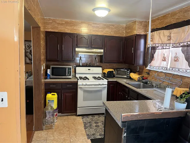 a kitchen with a sink cabinets and stainless steel appliances