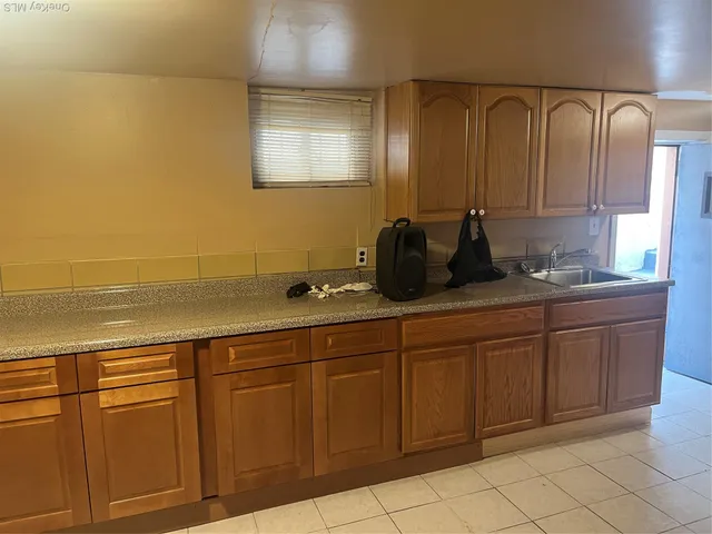a bathroom with a granite countertop sink and mirror