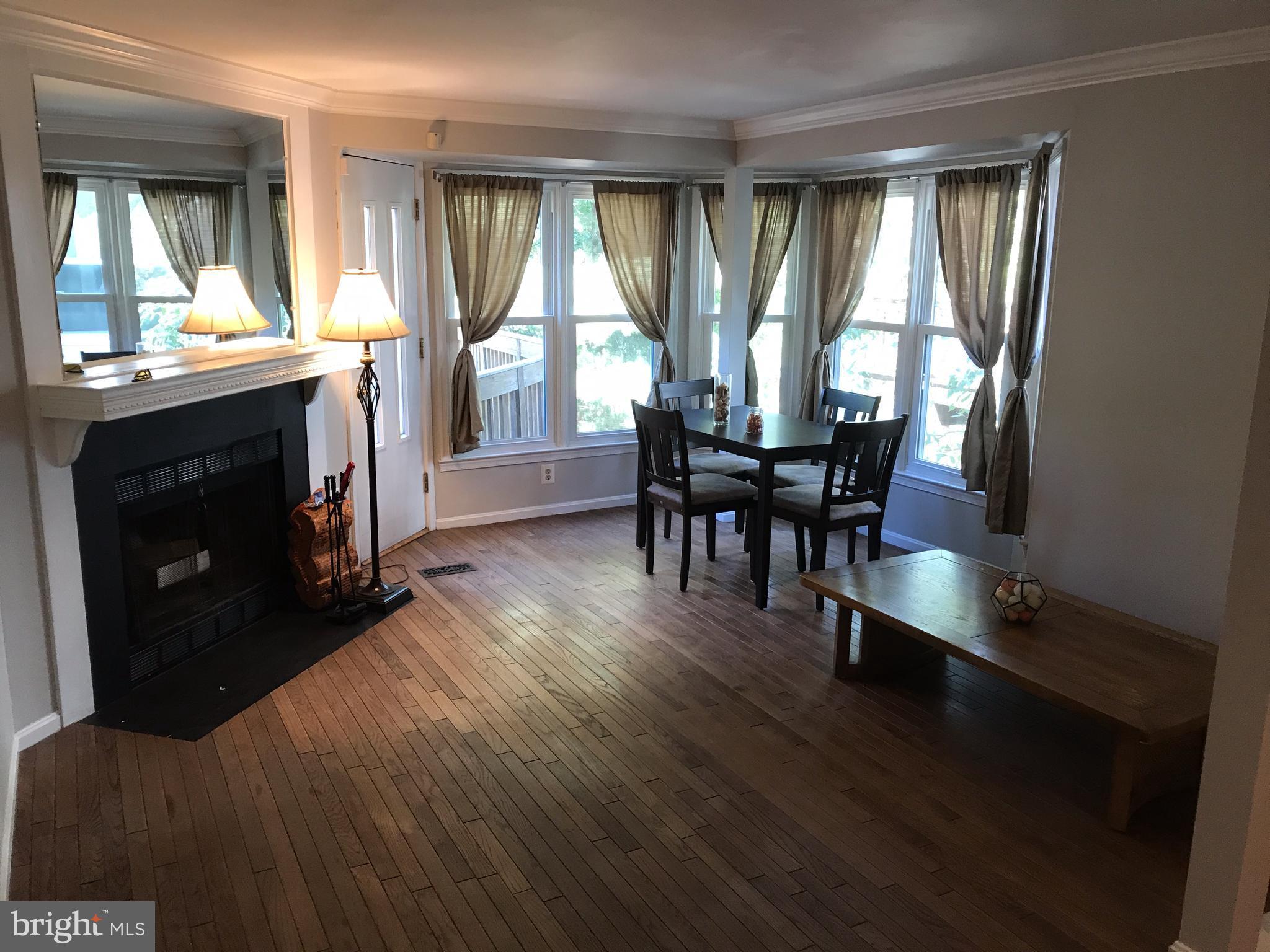 1717 Whisperhill Drive Reston, VA 20194 - Photo 2 of 10 a living room with furniture and a fireplace