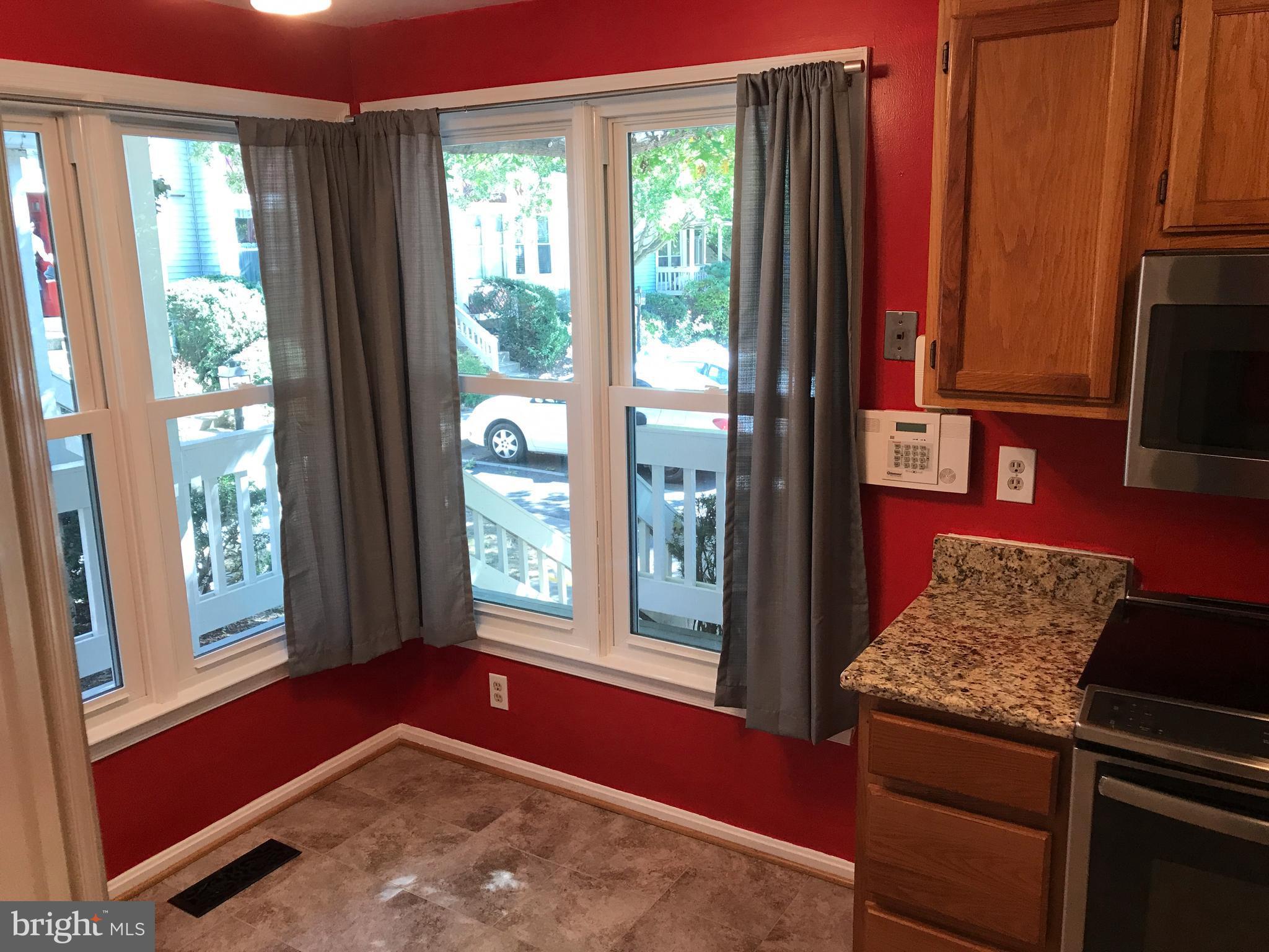 1717 Whisperhill Drive Reston, VA 20194 - Photo 4 of 10 a kitchen with stainless steel appliances granite countertop a stove a refrigerator and a window