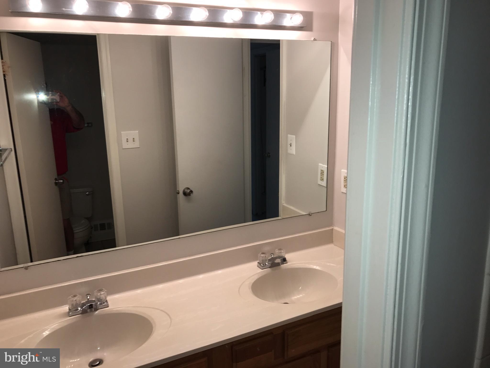 1717 Whisperhill Drive Reston, VA 20194 - Photo 8 of 10 a bathroom with a sink and a mirror